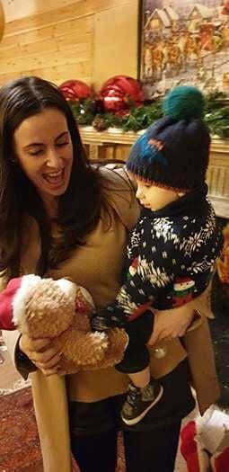 Mother holding and kissing happy baby boy