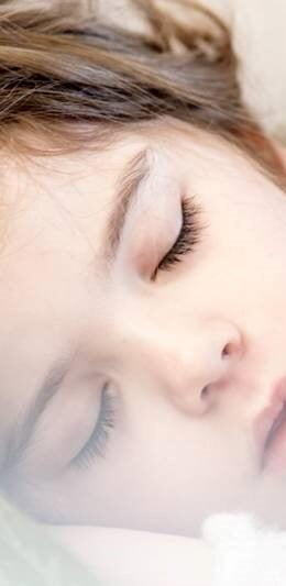 Girl with brown hair asleep