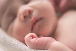 Newborn baby asleep on back